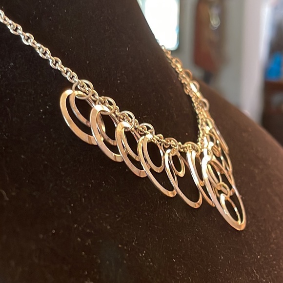 Light silver toned necklace with a variety of circles suspended on silver chain - Picture 9 of 13